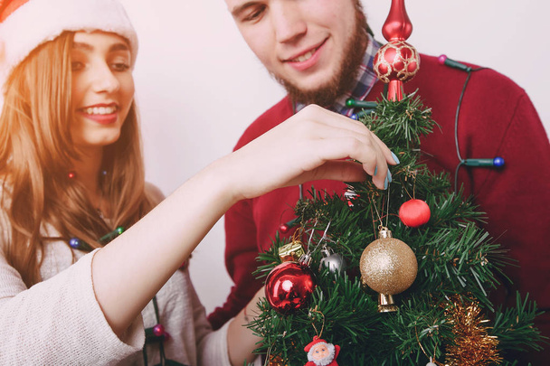 loving couple decorating Christmas tree - Fotoğraf, Görsel