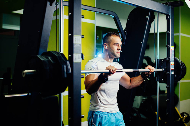 handsome fitness man weightlifting workout in gym - Photo, Image