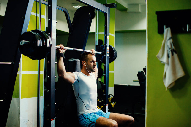 handsome fitness man weightlifting workout in gym - Fotó, kép