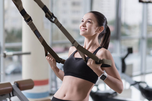 Young woman training hard in a gym - Фото, изображение