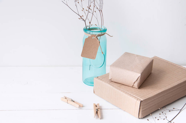 Minimal elegant composition with turquoise vase and craft boxes - Fotoğraf, Görsel