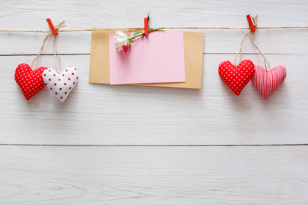 Valentine day background, pillow hearts and card on wood - Photo, Image