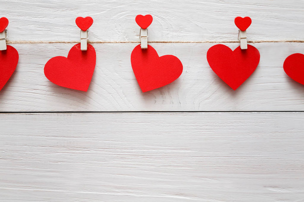 Valentine day background, paper hearts border on wood, copy space - 写真・画像
