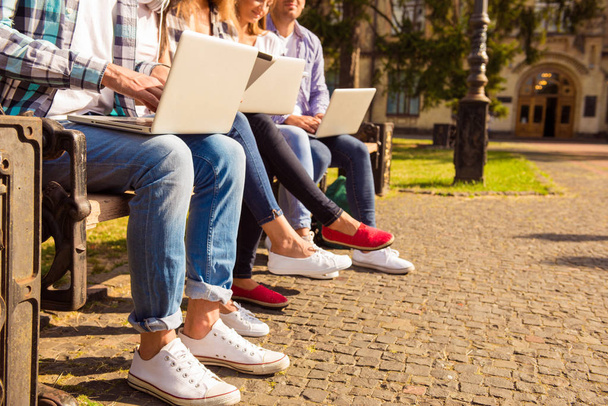 close-up photo of  diverse students sitting on bench and study u - Foto, Imagen