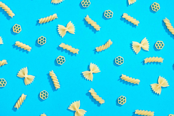 Farfalle, rotelle and fusilli pasta flat lay - Fotoğraf, Görsel