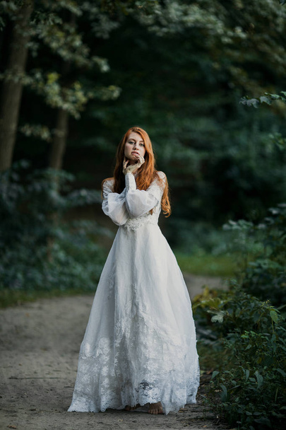 Young sexy redhead woman in white bridal vintage dress - Foto, Imagem