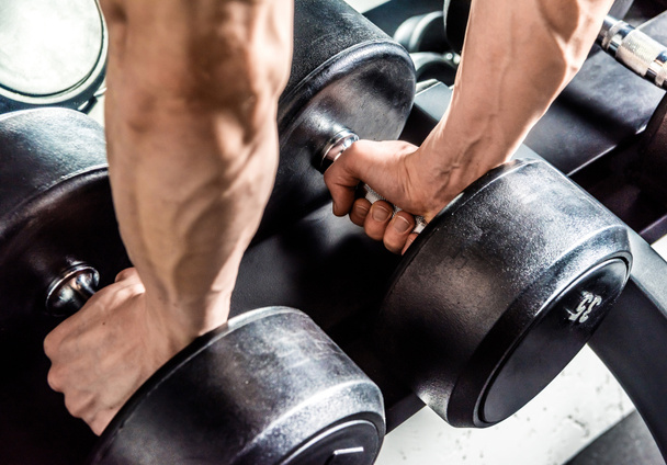 Dumbbells in male hands - Photo, Image