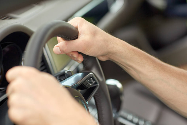 close up of male hands driving car - Fotó, kép