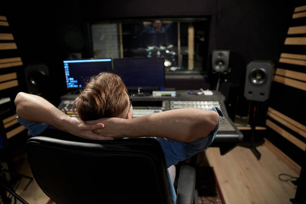 man at mixing console in music recording studio - Photo, Image