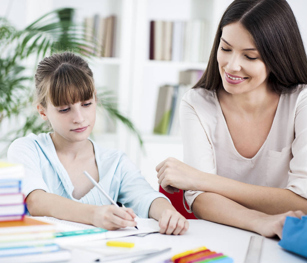 Mother and Daughter Doing Homework Together - Фото, зображення