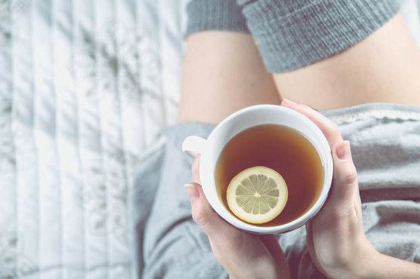 Cozy winter concept with girl drinking hot tea - Foto, Imagen