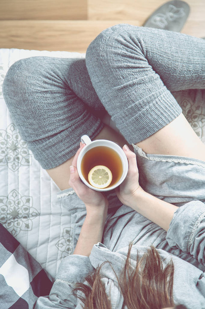 Cozy winter concept with girl drinking hot tea - Foto, Imagem