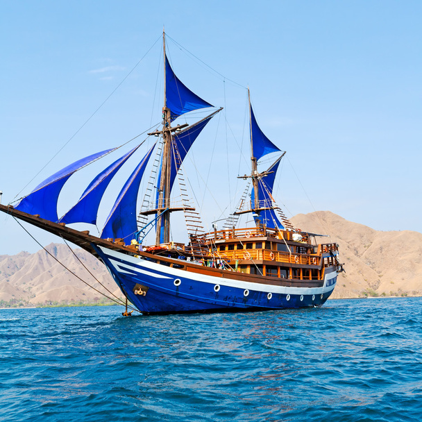 Vintage Wooden Ship with Blue Sails - Photo, Image
