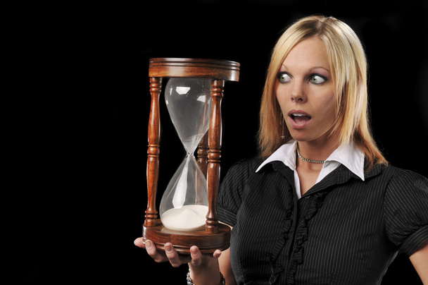 Woman holding a sand timer - Photo, Image
