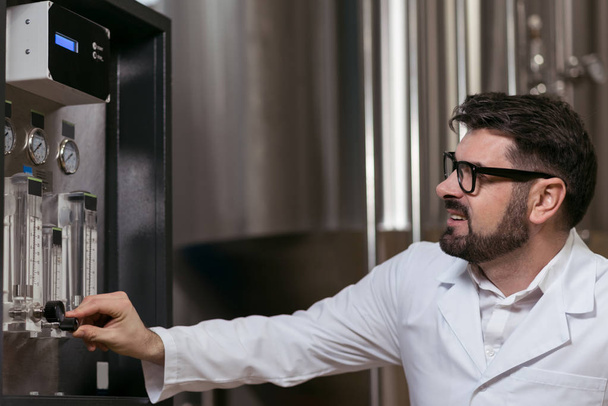 Concentrated man using brewing mechanism - Photo, Image