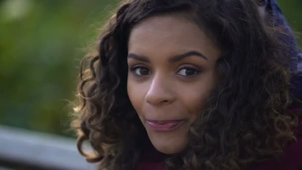 Beautiful biracial woman posing for camera and smiling sincerely, face close-up - Video