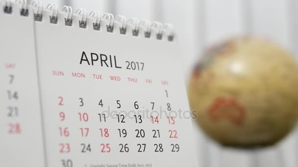 Motion of April 2017 calendar with blur earth globe turning background - Footage, Video