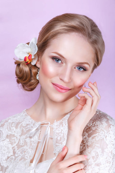 Beautiful bride with fashion wedding hairstyle - on pink background.Closeup portrait of young gorgeous bride. Wedding. Studio shot. - Fotografie, Obrázek