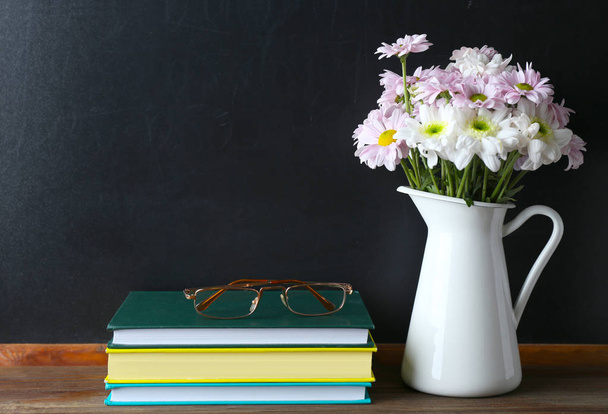 Bouquet of flowers, books with glasses  - Foto, Imagen