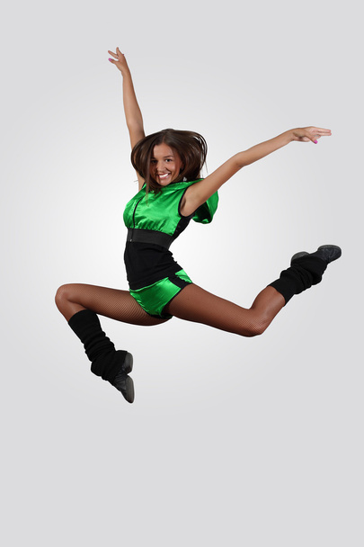 Young female dancer against white background - Фото, изображение