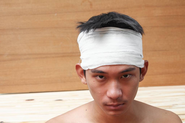 Young man with trauma of the head. by Medical bandage  - Photo, Image