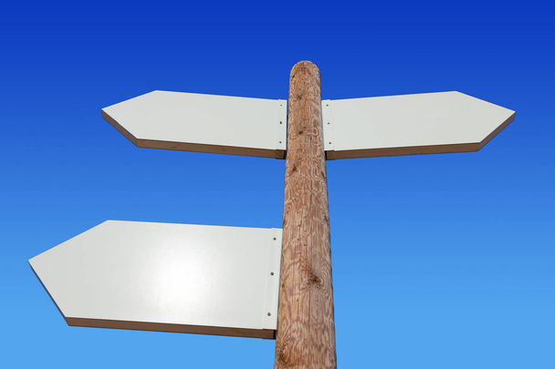 Empty arrow shaped signs in the middle of the desert with blue sky and mountains in the background - Photo, Image
