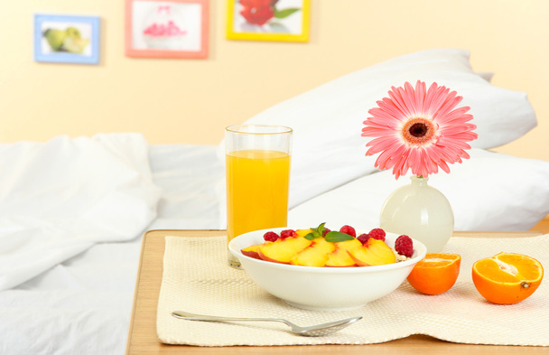 light breakfast on the nightstand next to the bed - Фото, зображення