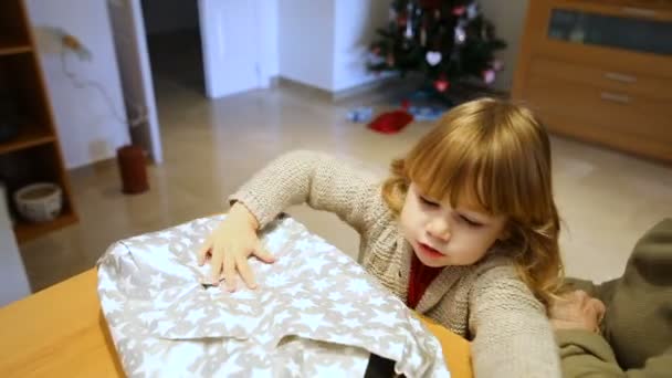 child opening Christmas gift with grandmother - Materiał filmowy, wideo