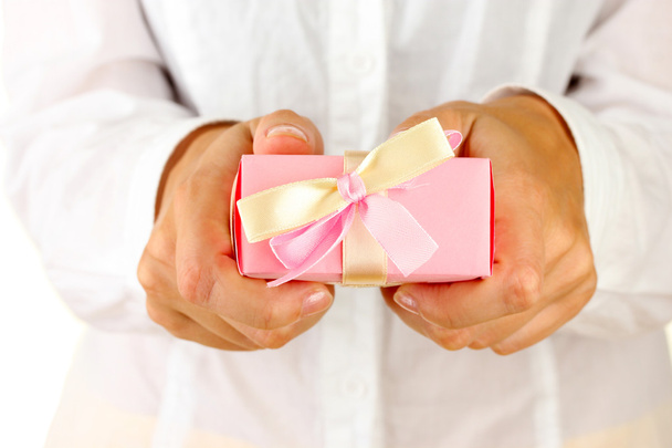 woman holds a box with a gift on white background close-up - Φωτογραφία, εικόνα