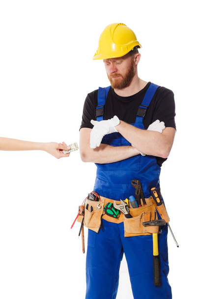 Man builder in the uniform and white gloves - Photo, Image