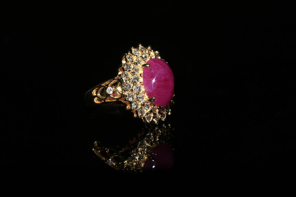 Jewellery diamond ring and gemstone on a black background - Foto, afbeelding