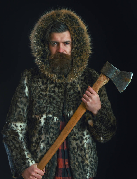 bearded man in fur with axe - Valokuva, kuva