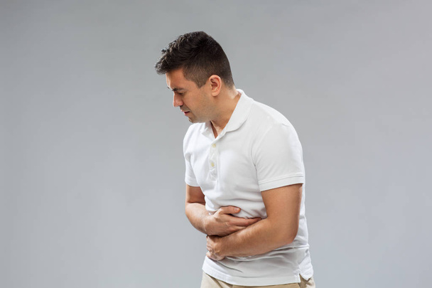 unhappy man suffering from stomach ache - Photo, Image