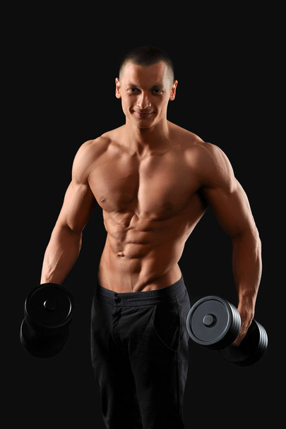 Male bodybuilder posing in studio - Fotó, kép