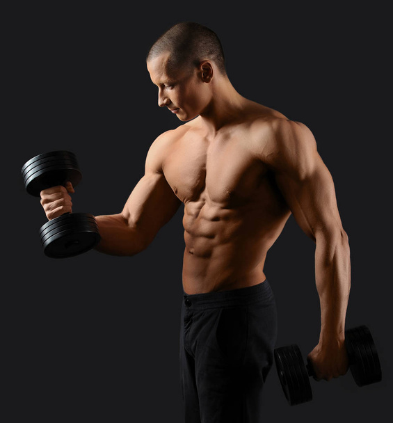 Male bodybuilder posing in studio - Photo, image