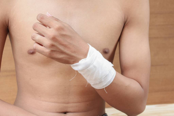 Bandage elastic. Pain and injury concept. Young man holds bandaged - Photo, Image