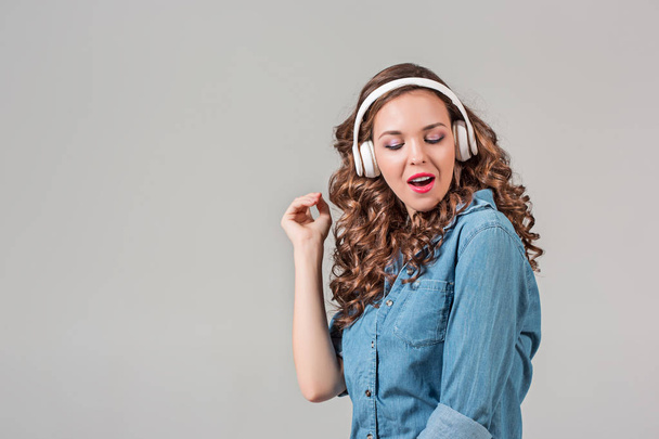 Happy young woman listening music with headphones. - Valokuva, kuva