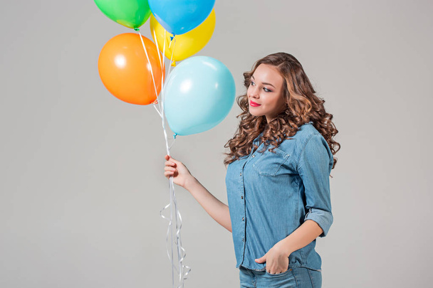girl with bunch of colorful balloons - Фото, изображение
