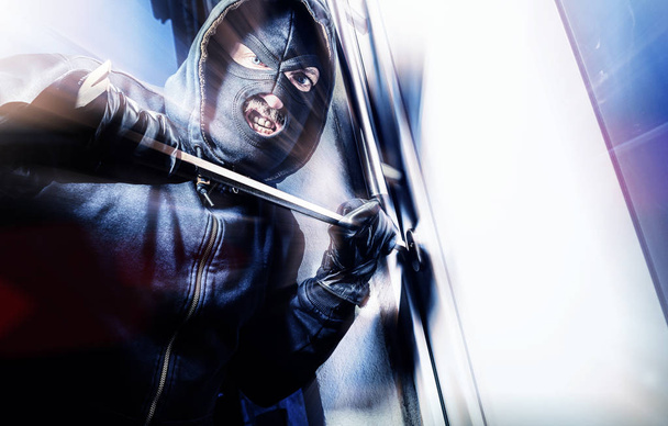 masked burglar with crowbar - Foto, imagen