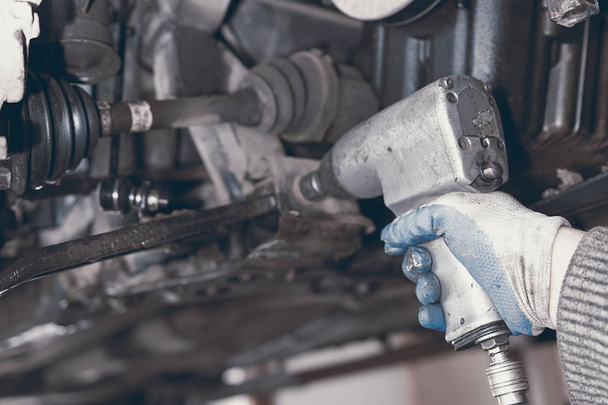 Hands of car mechanic in auto repair service. - Foto, Imagen