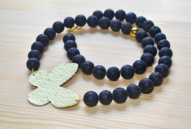 gemstone black lava necklace with gold butterfly - Photo, Image