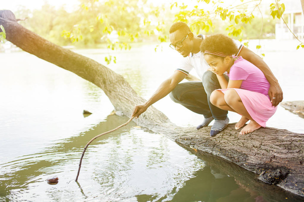 African American family playing around the lake - Φωτογραφία, εικόνα