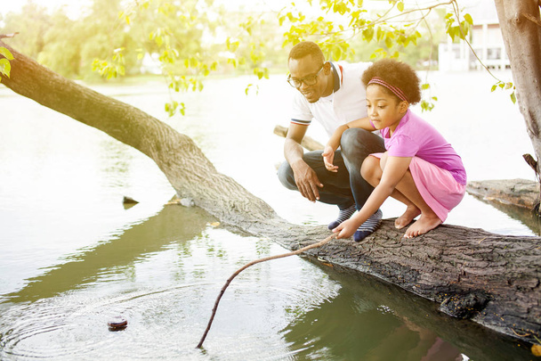 African American family playing around the lake - Foto, immagini