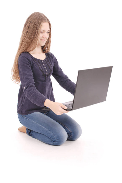 Étudiant adolescent fille assis latéralement sur le sol avec ordinateur portable
 - Photo, image