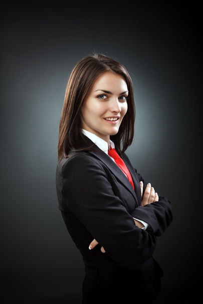 Happy young businesswoman wearing suit and necktie, isolated on - Photo, Image