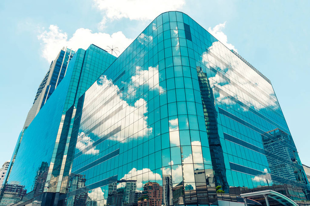 Современные стеклянные небоскребы с голубым облачным отражением неба
 - Фото, изображение