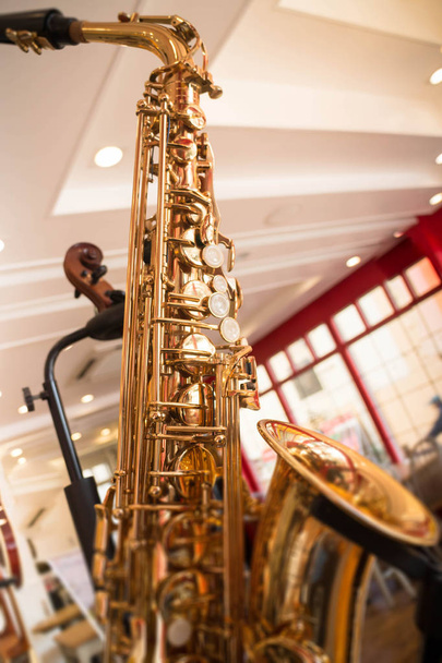 Golden saxophone show in the shop - Photo, Image