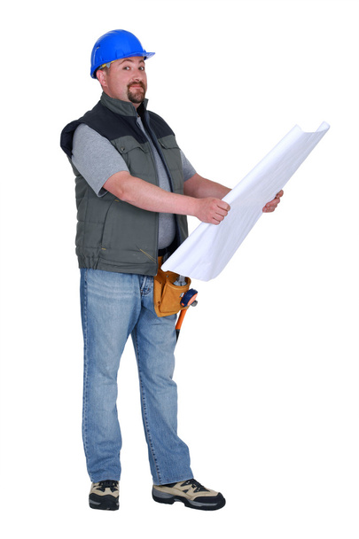 Builder looking at plans - Фото, изображение