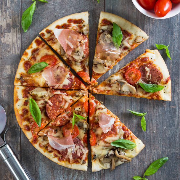 Pizza with salami, mushrooms and herbs - Foto, immagini