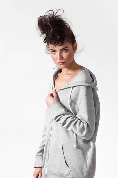 Beautiful woman portrait with messy hair wearing grey hoodie - Photo, image